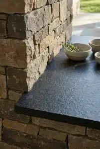 Close-up of heat-resistant leathered granite countertops on a custom outdoor kitchen island.